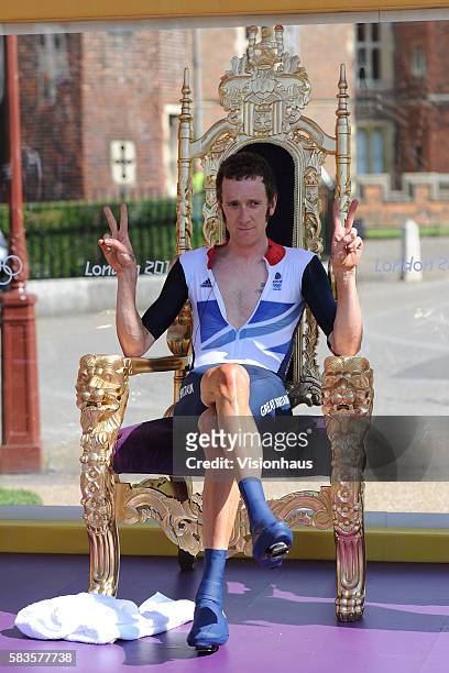 Bradley Wiggins of Great Britain relaxes in the winner's throne after the Men's Cycling Time Trial at Hampton Court Palace in Hampton Court, Surrey...