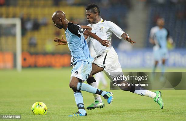 Asamoah Gyan of Ghana and Mompati Thuma of Botswana during the 2012 African Cup of Nations Group D match between Ghana and Botswana at Franceville...