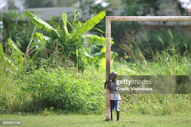 Young goalkeeper takes a rest from training for his school football team in Milong, Libreville, Gabon. Photo: Ben Radford/Visionhaus