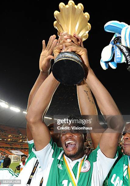 John Obi Mikel of Nigeria celebrates with the trophy after winning the 2013 African Cup of Nations Final match between Nigeria and Burkina Faso at...