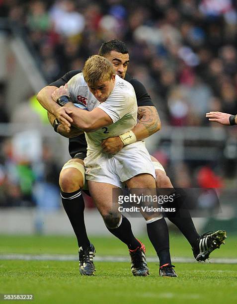 Tom Youngs of England is tackled by Liam Messam of New Zealand during the QBE international match between England and New Zealand at Twickenham...