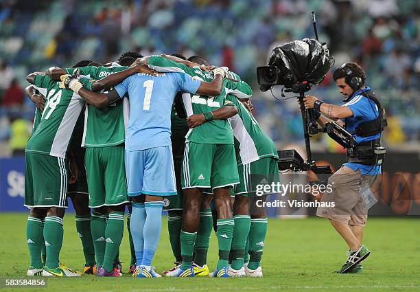 Television cameraman films the Nigeria team huddle using a steadicam camera during the 2013 African Cup of Nations Semi-final match between Mali and...