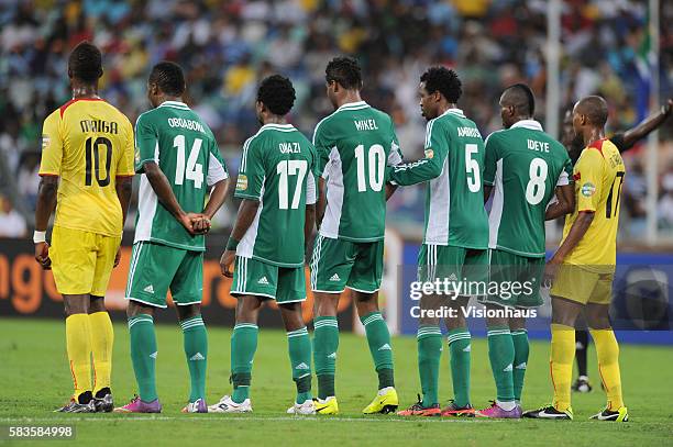 Modibo Maiga and Seydou Keita of Mali attach themselves to the ends of the Nigeria defensive wall during the 2013 African Cup of Nations Semi-final...