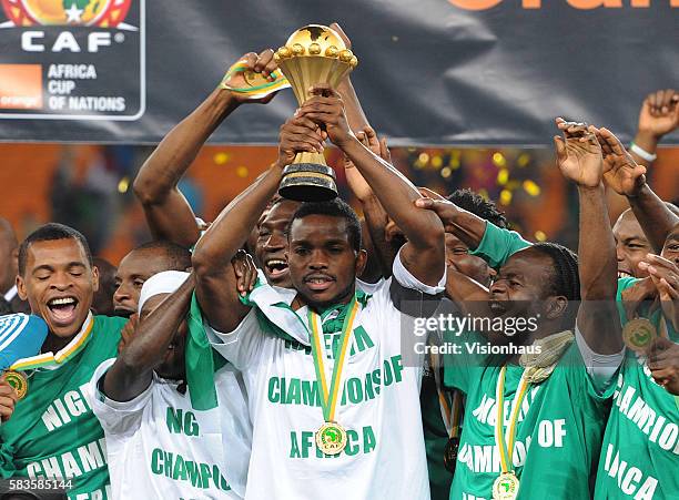 Victor Moses celebrates as Joseph Yobo of Nigeria lifts the trophy after his team win the 2013 African Cup of Nations Final match between Nigeria and...