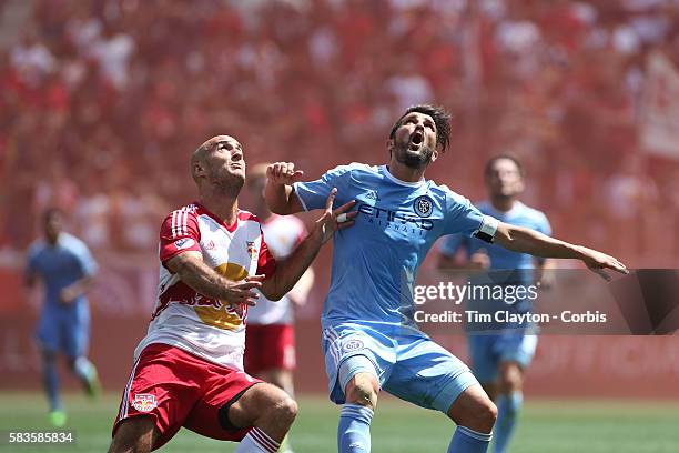 David Villa of New York City FC is challenged by Aurelien Collin of New York Red Bulls during the New York Red Bulls Vs New York City FC MLS regular...