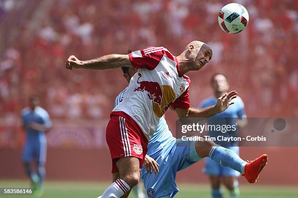 David Villa of New York City FC is challenged by Aurelien Collin of New York Red Bulls during the New York Red Bulls Vs New York City FC MLS regular...