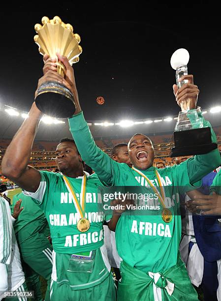 Nosa Igiebor and Emmanuel Emenike of Nigeria celebrate with the trophy after winning the 2013 African Cup of Nations Final match between Nigeria and...