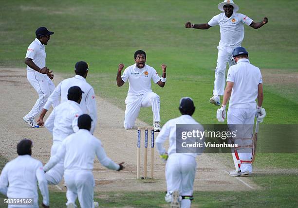 Dhammika Prasad of Sri Lanka celebrates taking the wicket of Gary Ballance during Day Four of the 2nd Investec Test between England and Sri Lanka at...