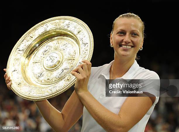 Petra Kvitova holds the Venus Rosewater Dish as she celebrates beating Eugenie Bouchard in the Ladies' Singles Final on Day Twelve of the 2014...