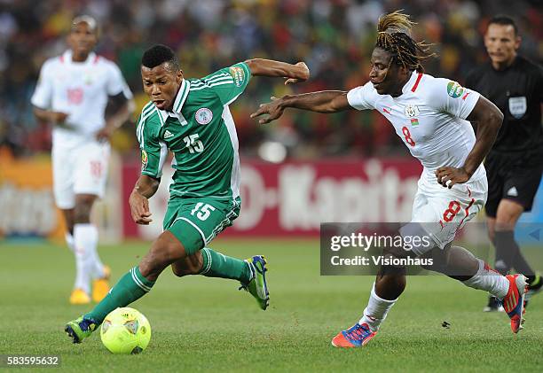 Ikechukwu Uche of Nigeria and Paul Koulibaly of Burkina Faso during the 2013 African Cup of Nations Final match between Nigeria and Burkina Faso at...