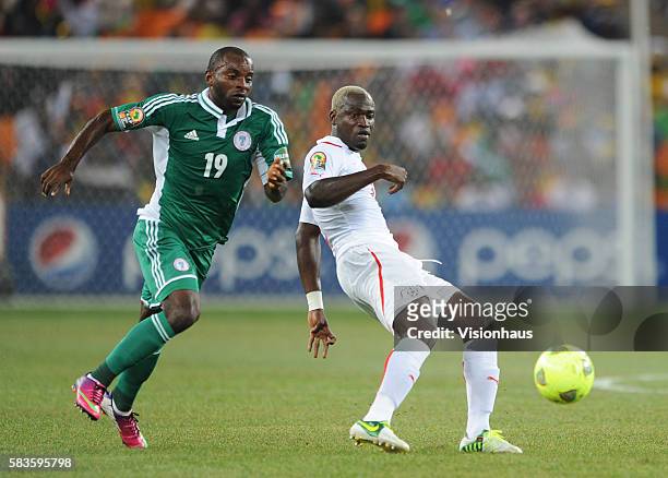Sunday Mba of Nigeria and Djakaridja Kone of Burkina Faso during the 2013 African Cup of Nations Final match between Nigeria and Burkina Faso at the...