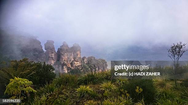 cloud over the three sisters - australian rainforest stock pictures, royalty-free photos & images