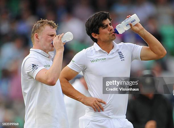 England Captain Alastair Cook and Sam Robson have a drink during Day One of the 5th Investec Test between England and India at the Kia Oval in...