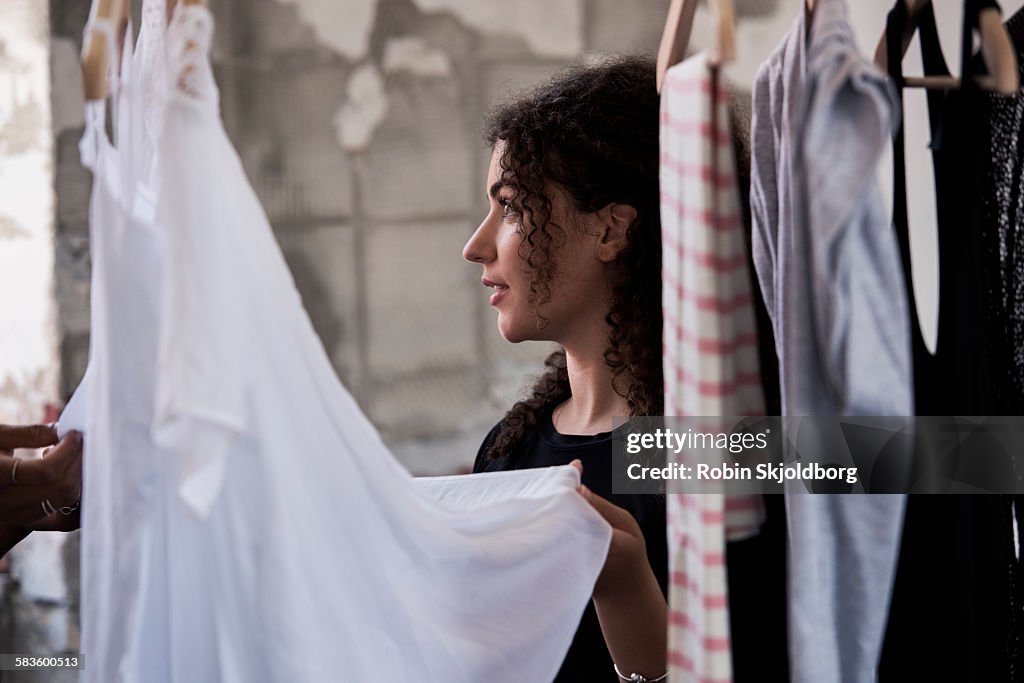 Woman looking at clothes on rack