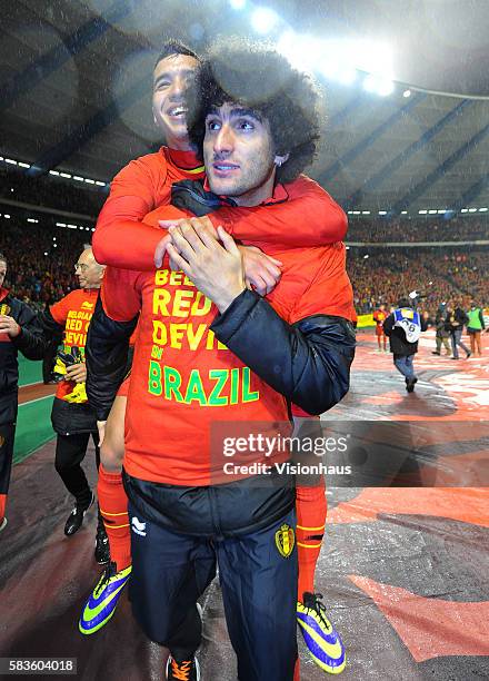 Marouane Fellaini and Zakaria Bakkali of Belgium celebrate qualication to the 2014 World Cup after the FIFA 2014 World Cup Qualifying Group A match...