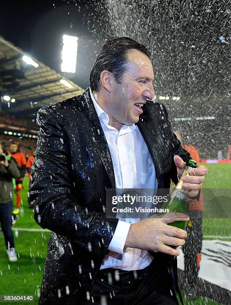 Marc Wilmots, the Belgian head coach, is sprayed with champagne during celebrations after qualifiying for the World Cup Finals in Brazilduring the...