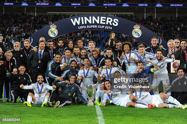 Real Madrid players and officials celebrate winning the UEFA Super Cup Final between Real Madrid CF and Sevilla FC at the Cardiff City Stadium in...