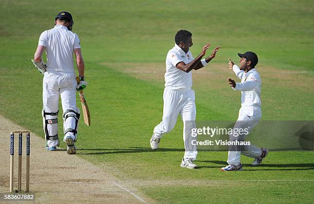 Dhammika Prasad of Sri Lanka celebrates taking the wicket of Sam Robson with Kaushal Silva during Day Four of the 2nd Investec Test between England...