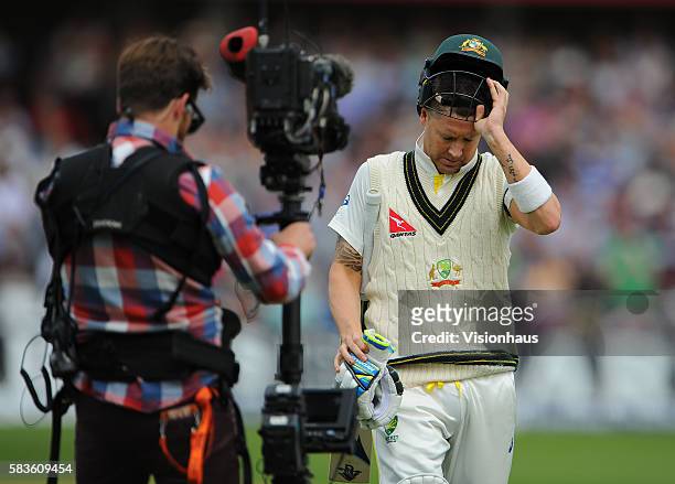 Australian Captain Michael Clarke is followed off the pitch by a Sky Sports steadicam cameraman after losing his wicket to Stuart Broad during the...