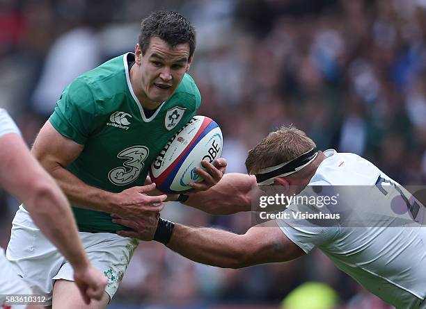 Jonathan Sexton of Ireland is tackled by Tom Youngs of England during the QBE International match between England and Ireland at Twickenham Stadium...