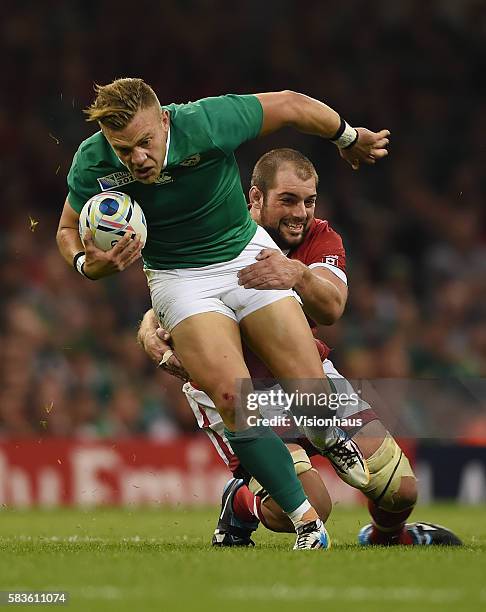 Ian Madigan of Ireland is tackled by Brett Beukeboom of Canada during the Rugby World Cup pool D group match between Ireland and Canada at the...