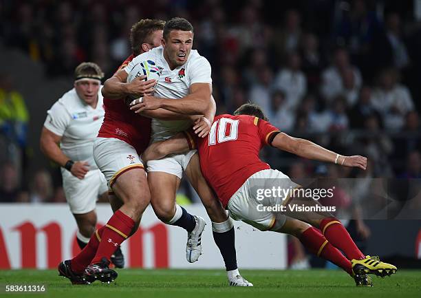 Sam Burgess of England is tackled by Tomas Francis and Dan Biggar of Wales during the Rugby World Cup 2015 Group A match between England and Wales at...