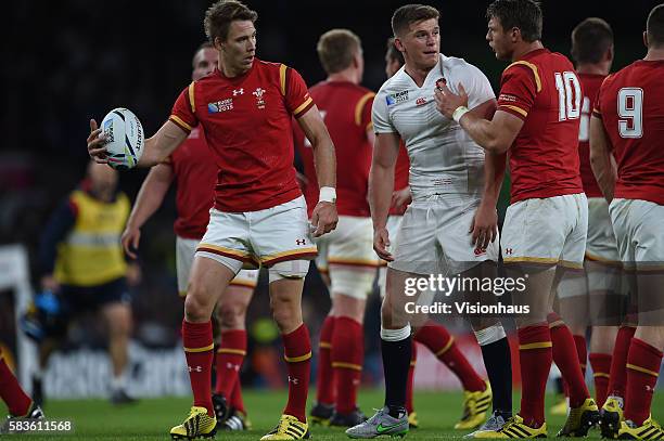 Liam Williams and Dan Biggar of Wales try to wind uo Owen Farrell of England by refusing to give hm the ball during the Rugby World Cup 2015 Group A...