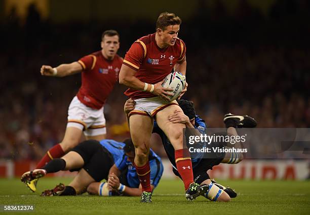 Hallam Amos of Wales is tackled by Matias Beer of Uruguay during the Rugby World Cup pool A group match between Wales and Uruguay at the Millennium...