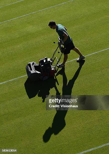 All England Club ground staff prepare one of the grass courts for the start of play on Day Two of the 2015 Wimbledon Lawn Tennis Championships at the...