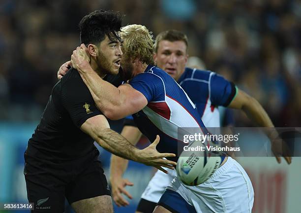 Nehe Milner-Skudder of New Zealand is tackled by Conrad Marais of Namibia during the Rugby World Cup 2015 Group C match between New Zealand and...