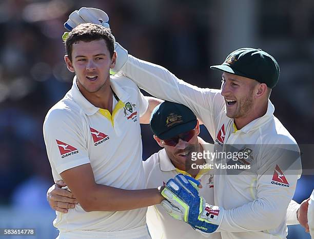 Josh Hazlewood of Australia celebrates taking the wicket of Joe Root with David Warner and Peter Nevill during the fourth day of the 2nd Investec...