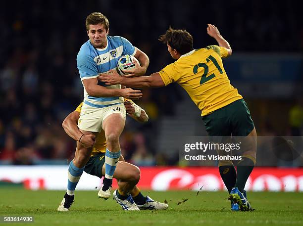 Santiago Cordero of Argentina is tackled by Nick Phipps and Matt Toomua of Australia during the Rugby World Cup semi final match between Argentina v...