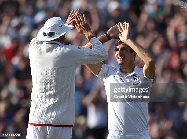 Steven Finn celebrates taking the wicket of Mitchell Johnson with Stuart Broad during the second day of the 3rd Investec Ashes Test between England...