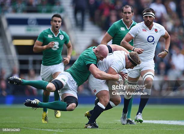 Tom Youngs of England is tackled by Paul O'Connell of Ireland during the QBE International match between England and Ireland at Twickenham Stadium in...