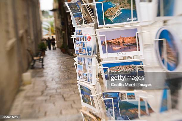 postcards for sale on narrow street in korcula - cartolina postale foto e immagini stock