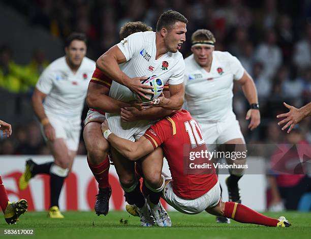 Sam Burgess of England is tackled by Tomas Francis and Dan Biggar of Wales during the Rugby World Cup 2015 Group A match between England and Wales at...