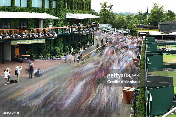 Five second shutter speed illustrates the crowd entering as the gates open at 10.30am on Day Four of the 2015 Wimbledon Lawn Tennis Championships at...