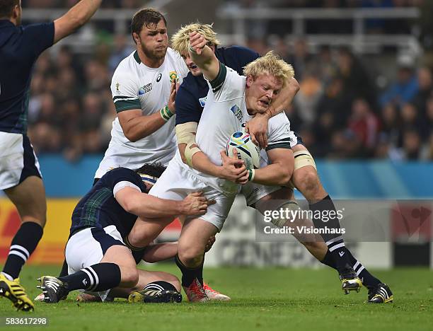 Adriaan Strauss of South Africa is tackled by Richie Gray of Scotland during the Rugby World Cup Pool B match between South Africa and Scotland at St...