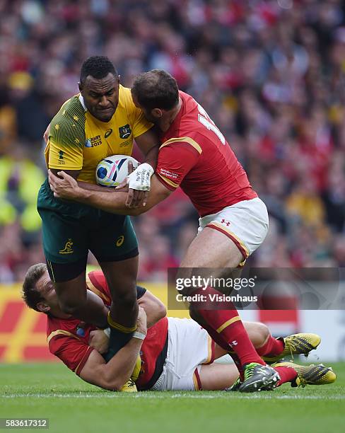 Tevita Kuridrani of Australia is tackled by Dan Biggar and Jamie Roberts of Wales during the Rugby World Cup 2015 Group A match between Australia and...