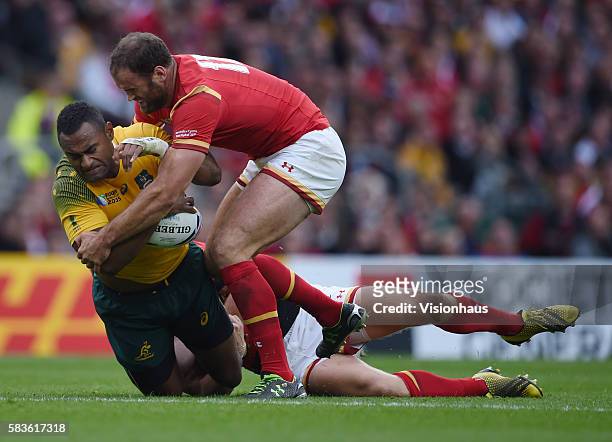 Tevita Kuridrani of Australia is tackled by Dan Biggar and Jamie Roberts of Wales during the Rugby World Cup 2015 Group A match between Australia and...