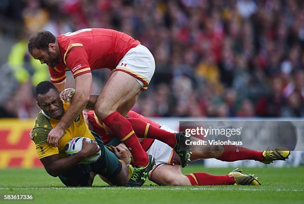 Tevita Kuridrani of Australia is tackled by Dan Biggar and Jamie Roberts of Wales during the Rugby World Cup 2015 Group A match between Australia and...