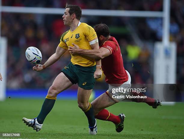 Bernard Foley of Australia is tackled by Jamie Roberts of Wales during the Rugby World Cup 2015 Group A match between Australia and Wales at...