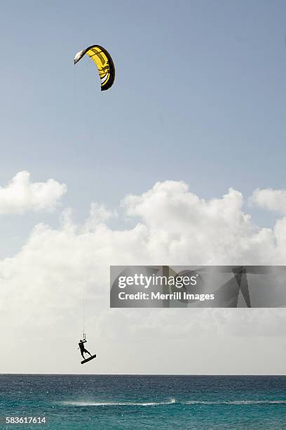 kite-surfer in mid-air above the caribbean sea - bonaire stockfoto's en -beelden