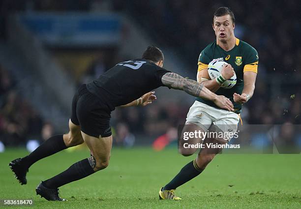 Handre Pollard of South Africa is tackled by Sonny Bill Williams of New Zealand during the Rugby World Cup 2015 Semi-Final match between South Africa...