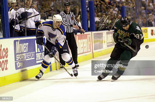 Marty Reasoner of the St. Louis Blues takes a shot past Brad Lukowich of the Dallas Stars during game 3 of Western Conference Semifinals at the...