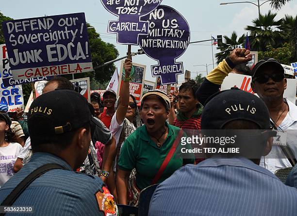 An activist shouts at police after they were blocked from marching to the US embassy during a protest, to coincide with US Secretary of State John...
