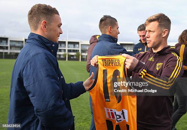 Kieran Trippier of Tottenham is presented a Hawks guernsey by Sam Mitchell of the Hawks during a Tottenham Hotspur player visit to the Hawthorn Hawks...