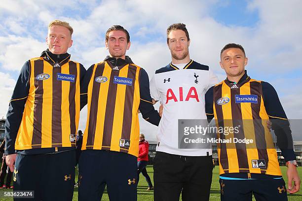 Thomas Glover Luke McGee and Kieran Trippier of Tottenham pose with James Frawley of the Hawks after they exchanged jumpers during a Tottenham...