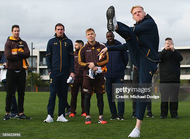 Thomas Glover of Tottenham kicks an AFL Football during a Tottenham Hotspur player visit to the Hawthorn Hawks AFL team at Waverley Park on July 27,...