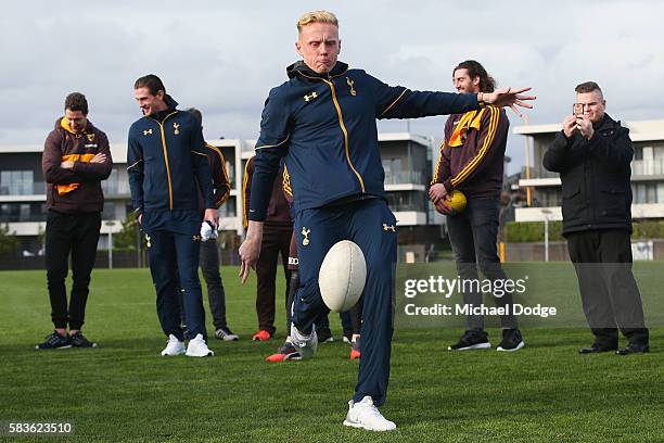 Thomas Glover of Tottenham kicks an AFL Football during a Tottenham Hotspur player visit to the Hawthorn Hawks AFL team at Waverley Park on July 27,...